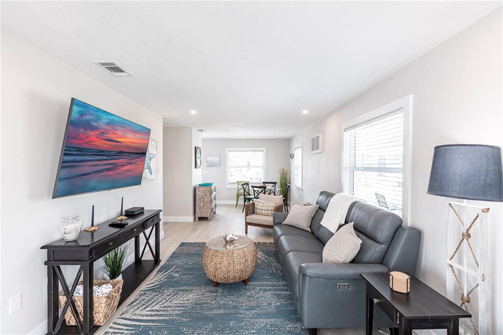 6020 Midnight Pass Road, Unit 56 Sarasota, FL 34242 - Photo 5 of 29 a living room with furniture and a flat screen tv