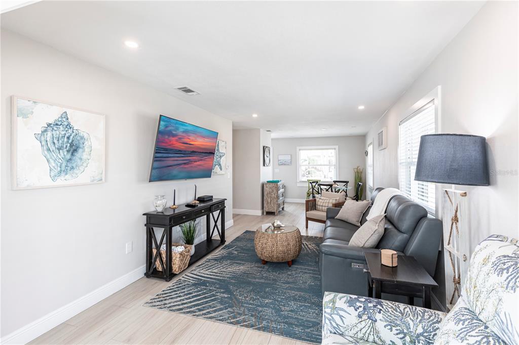 6020 Midnight Pass Road, Unit 56 Sarasota, FL 34242 - Photo 6 of 29 a living room with furniture and a flat screen tv