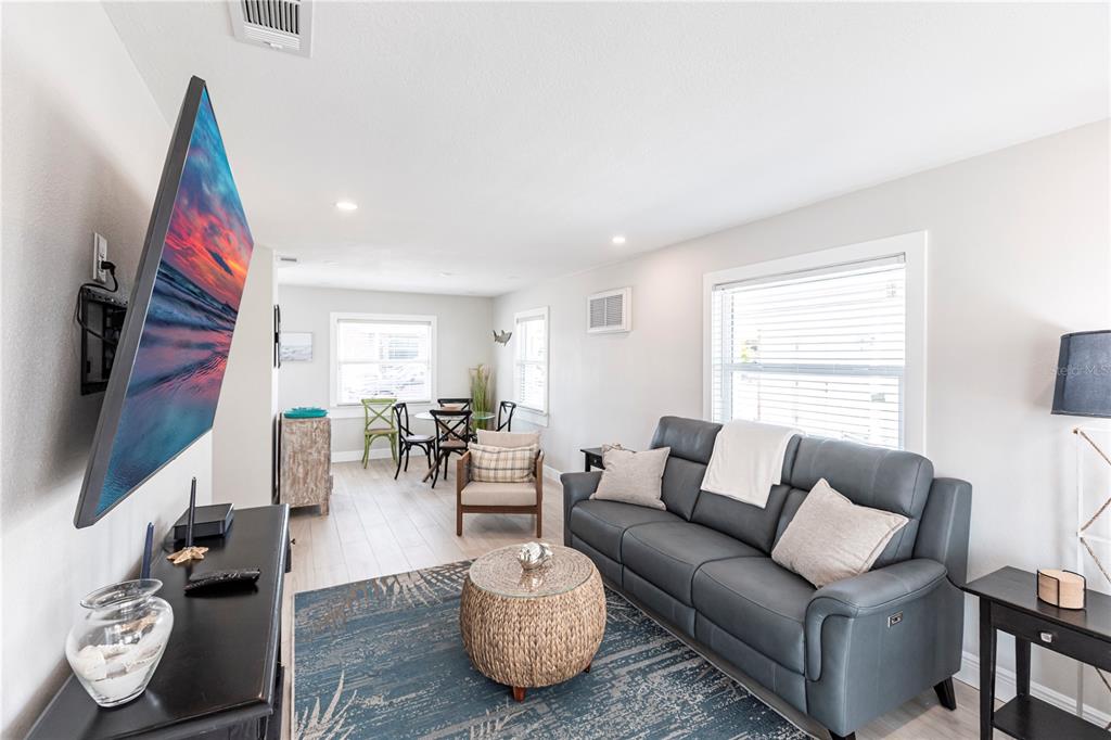 6020 Midnight Pass Road, Unit 56 Sarasota, FL 34242 - Photo 7 of 29 a living room with furniture and a flat screen tv