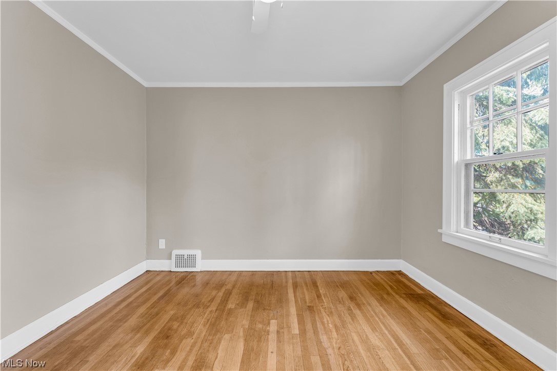 3609 Strandhill Road Shaker Heights, OH 44122 - Photo 5 of 47 Empty room with light hardwood / wood-style flooring and ornamental molding