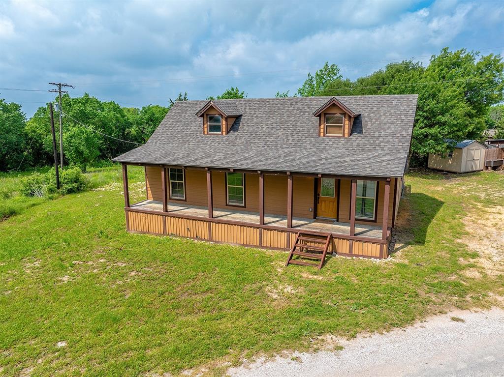 371 Spring Street Forestburg, TX 76239 - Photo 27 of 38 a house view with a sitting space garden and patio