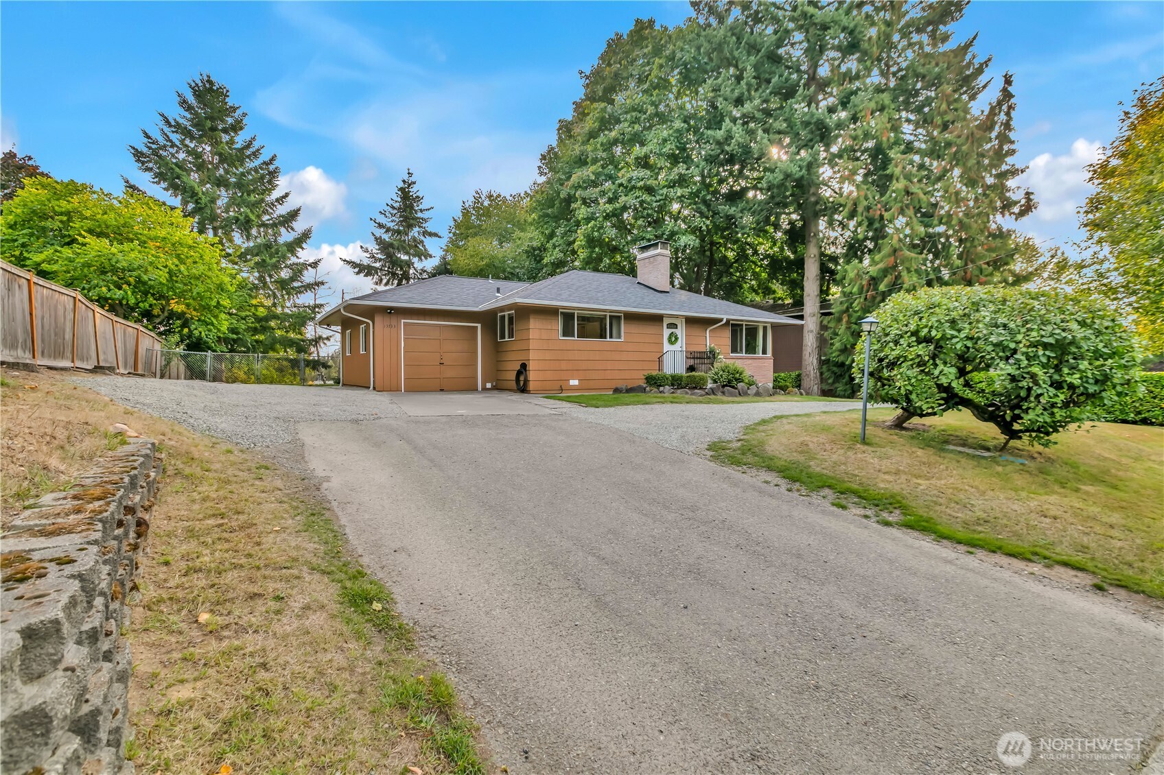 a front view of a house with a yard and trees