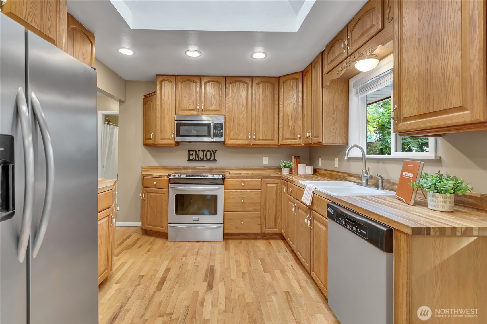 13733 Southeast 272nd Street Kent, WA 98042 - Photo 11 of 40 a kitchen with stainless steel appliances kitchen island granite countertop a stove a sink and a refrigerator