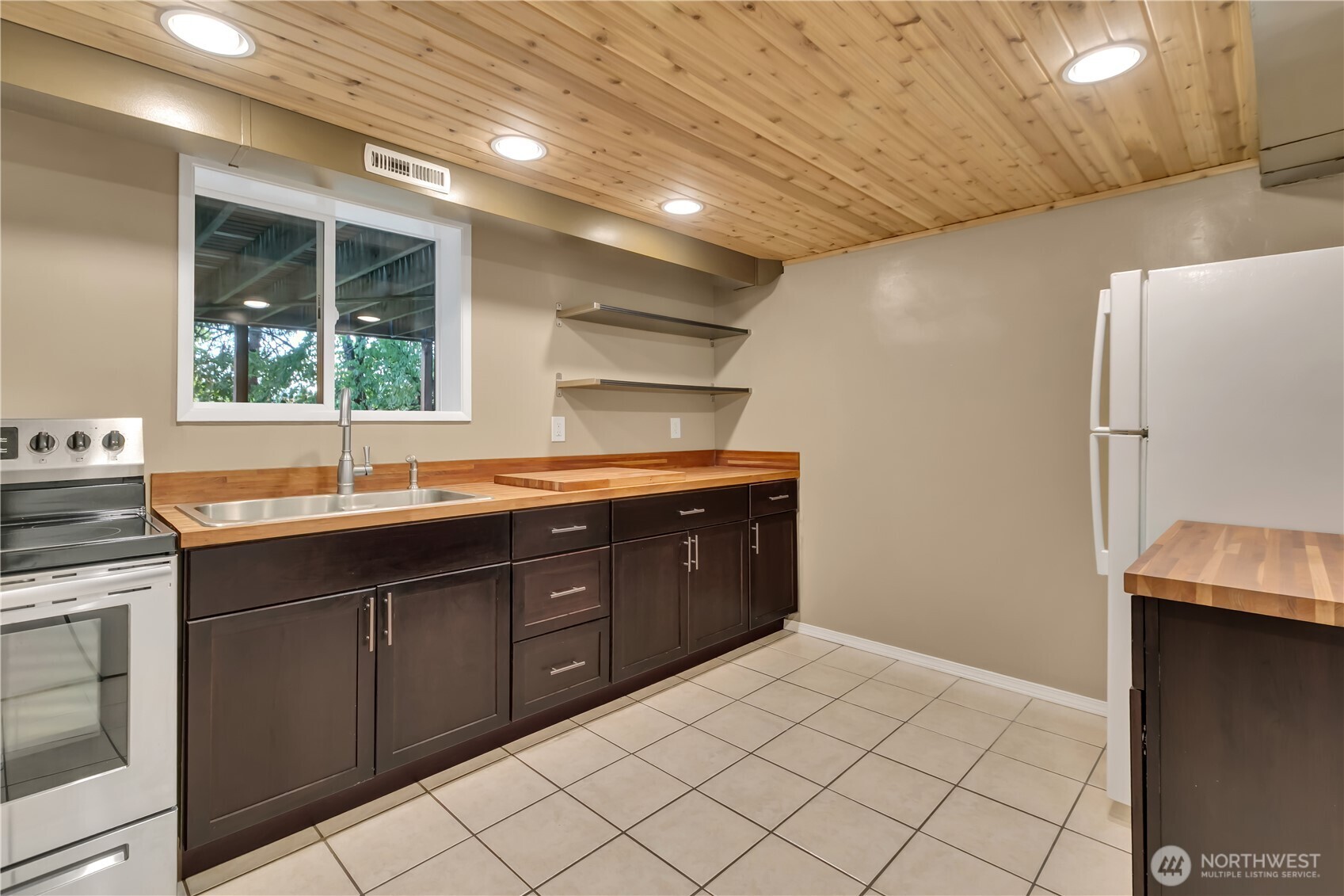 13733 Southeast 272nd Street Kent, WA 98042 - Photo 20 of 40 a kitchen with a sink and a refrigerator