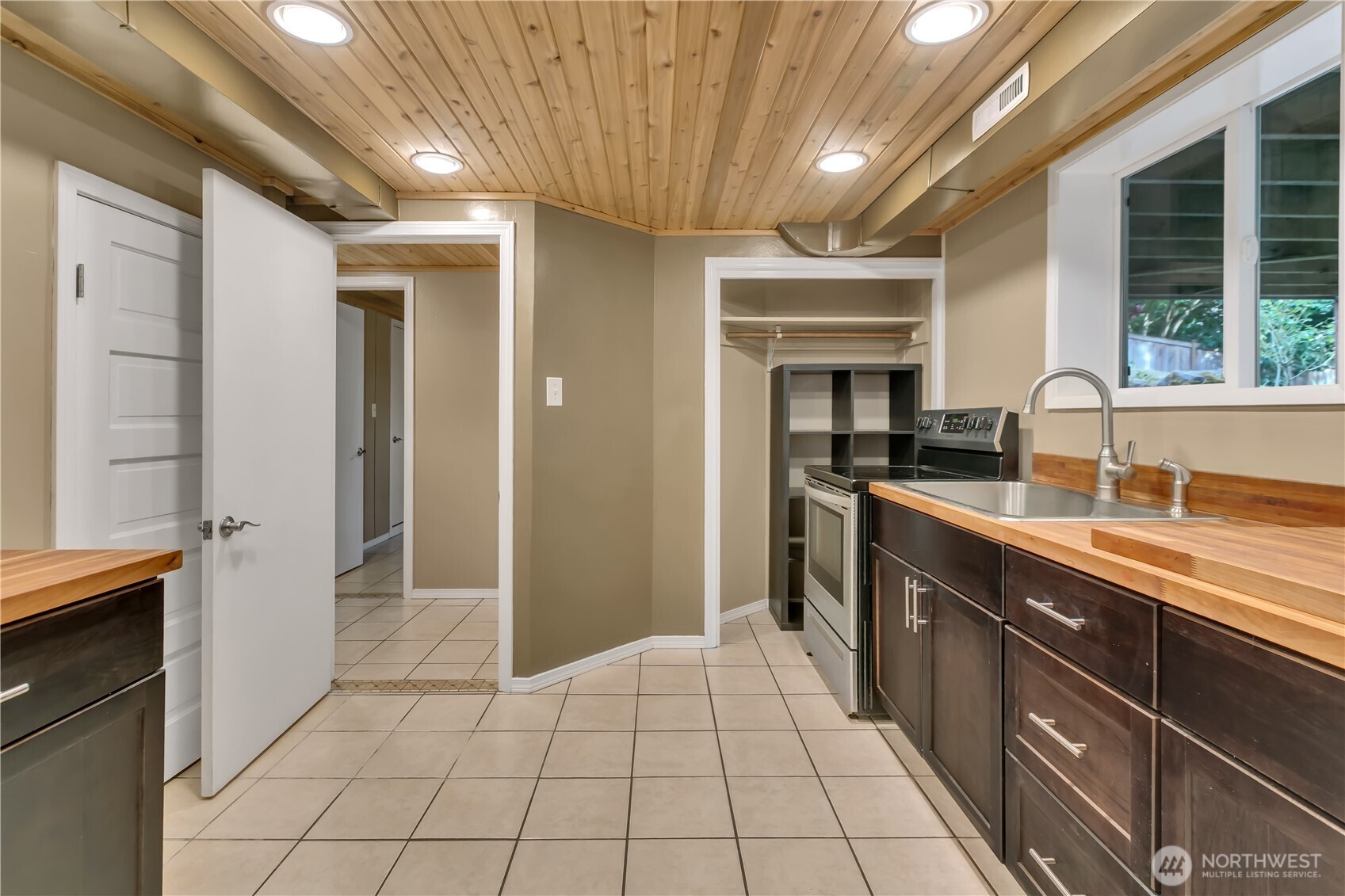 13733 Southeast 272nd Street Kent, WA 98042 - Photo 21 of 40 a kitchen with a sink a stove and cabinets