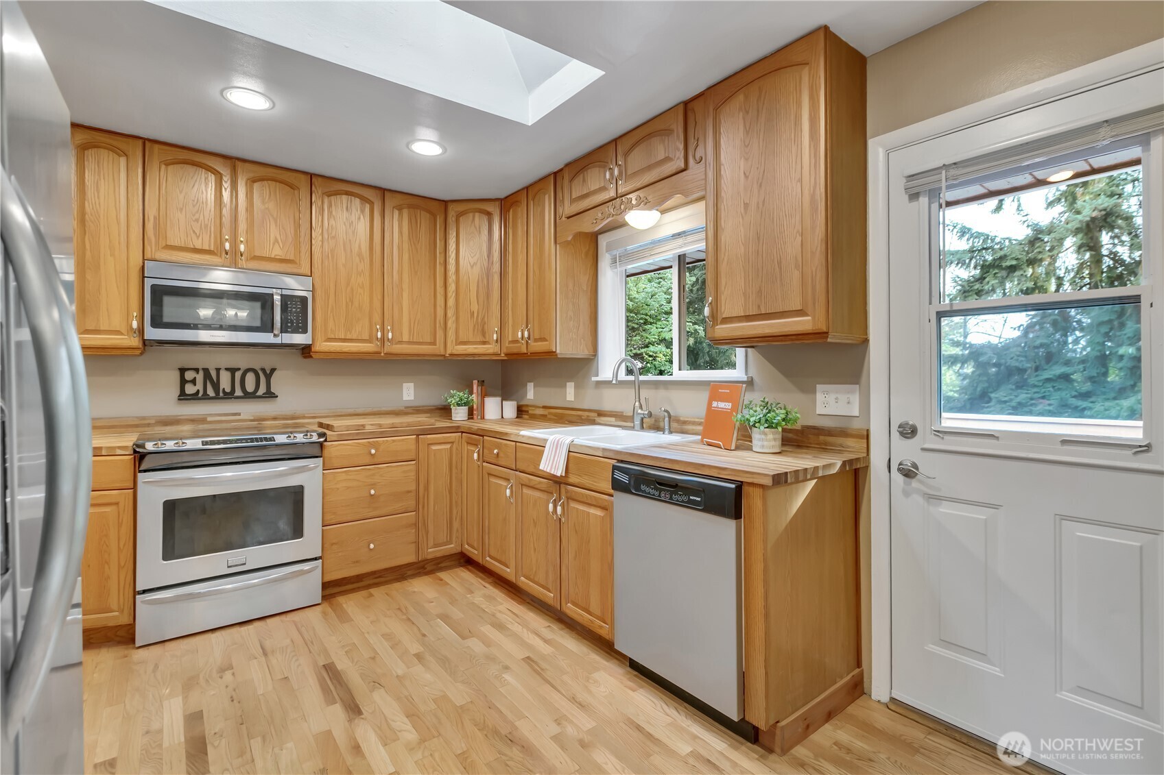 13733 Southeast 272nd Street Kent, WA 98042 - Photo 10 of 40 a kitchen with stainless steel appliances granite countertop a stove a sink and a microwave