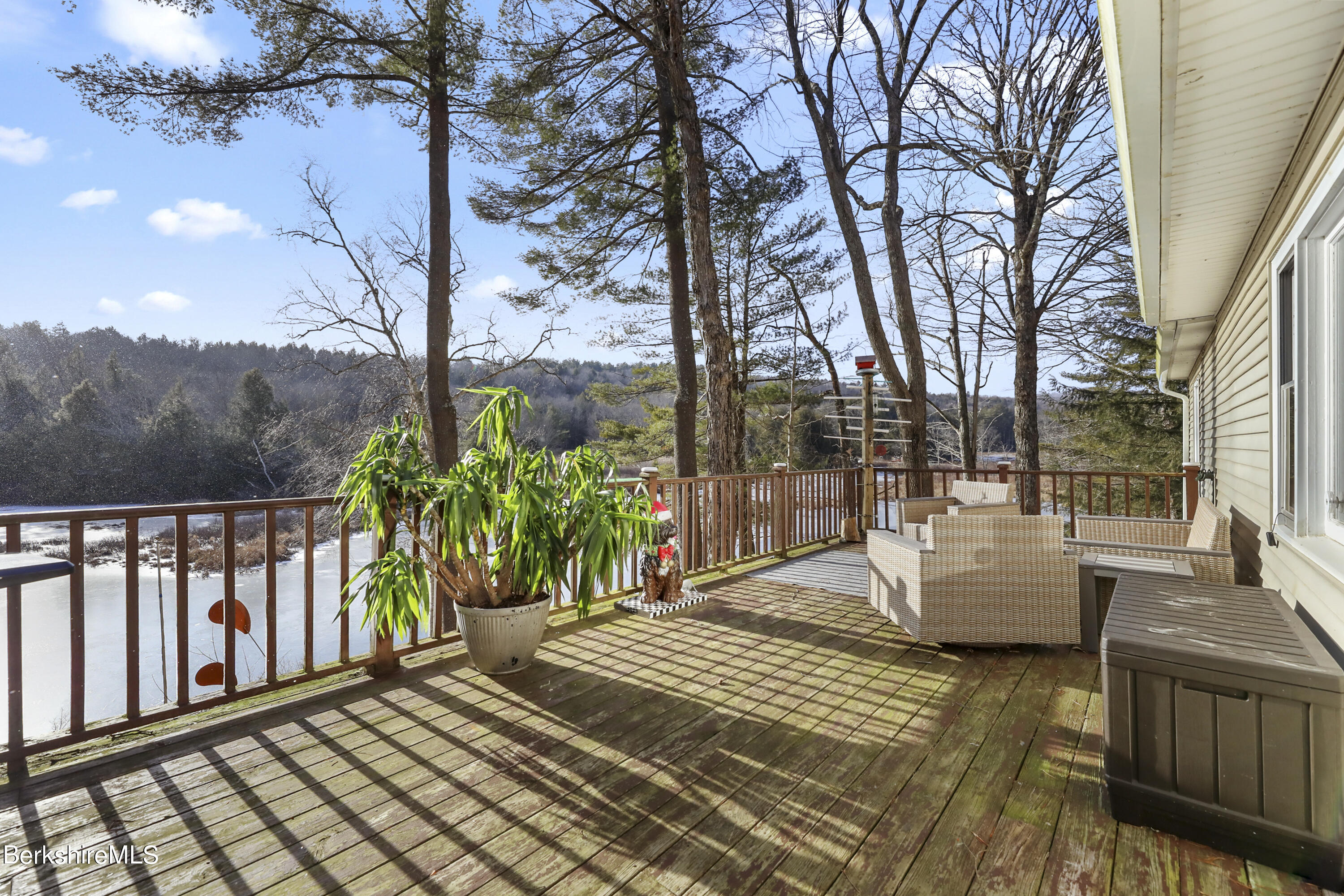 1831 North Main Road Otis, MA 01253 - Photo 15 of 69 a view of a roof deck with couches and wooden fence