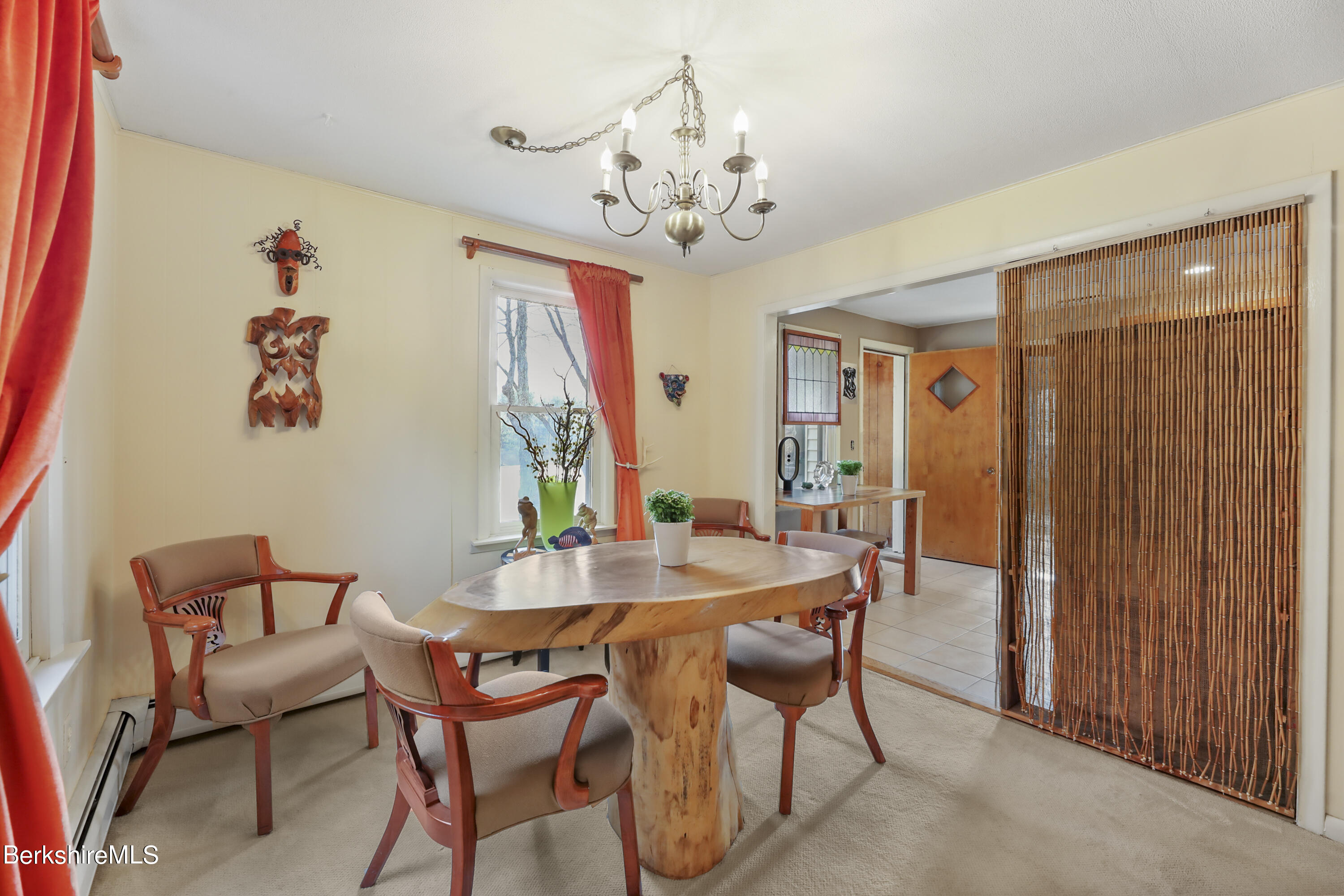 1831 North Main Road Otis, MA 01253 - Photo 25 of 69 a view of a dining room with furniture and a chandelier