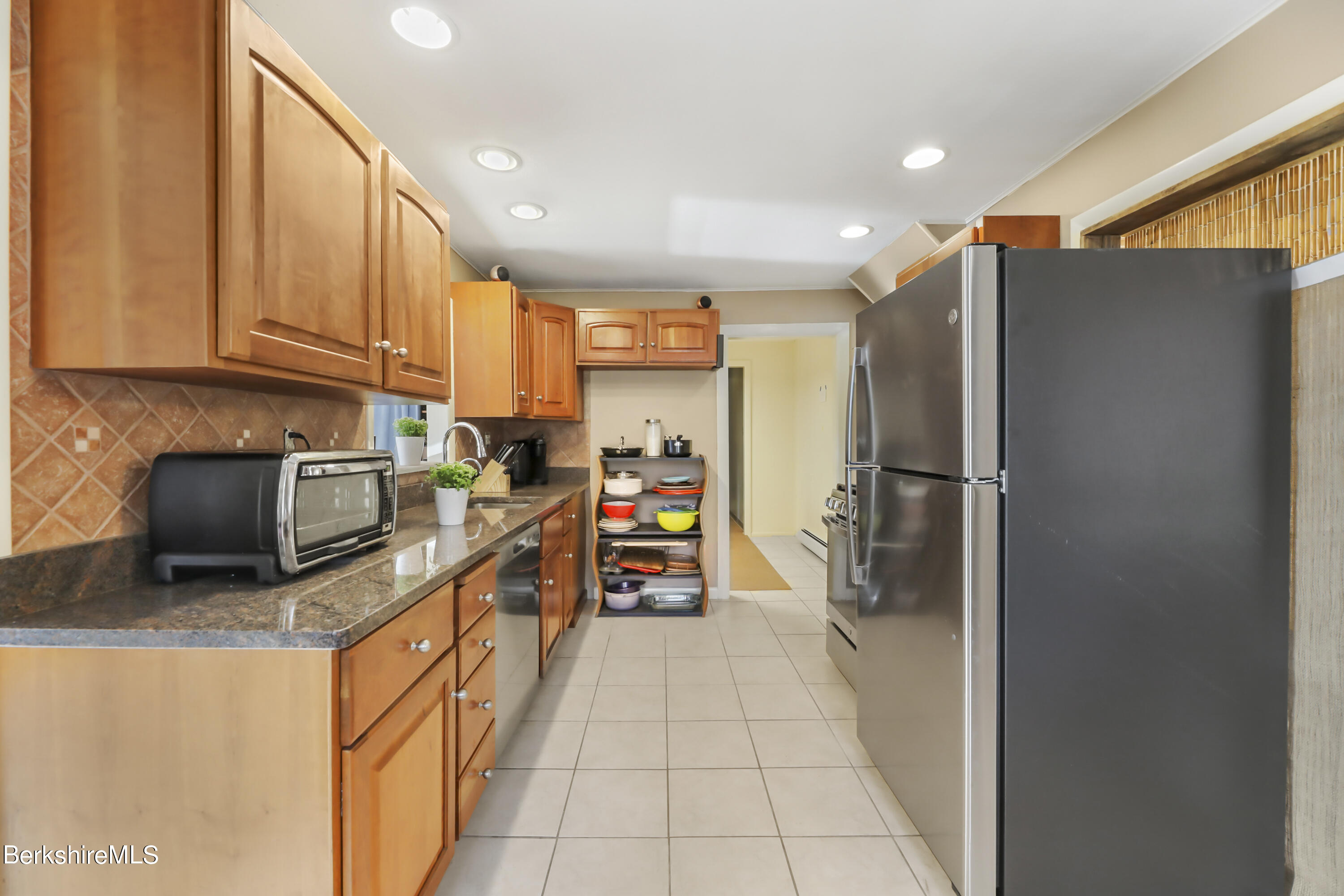 1831 North Main Road Otis, MA 01253 - Photo 28 of 69 a kitchen with stainless steel appliances granite countertop a refrigerator and a stove top oven