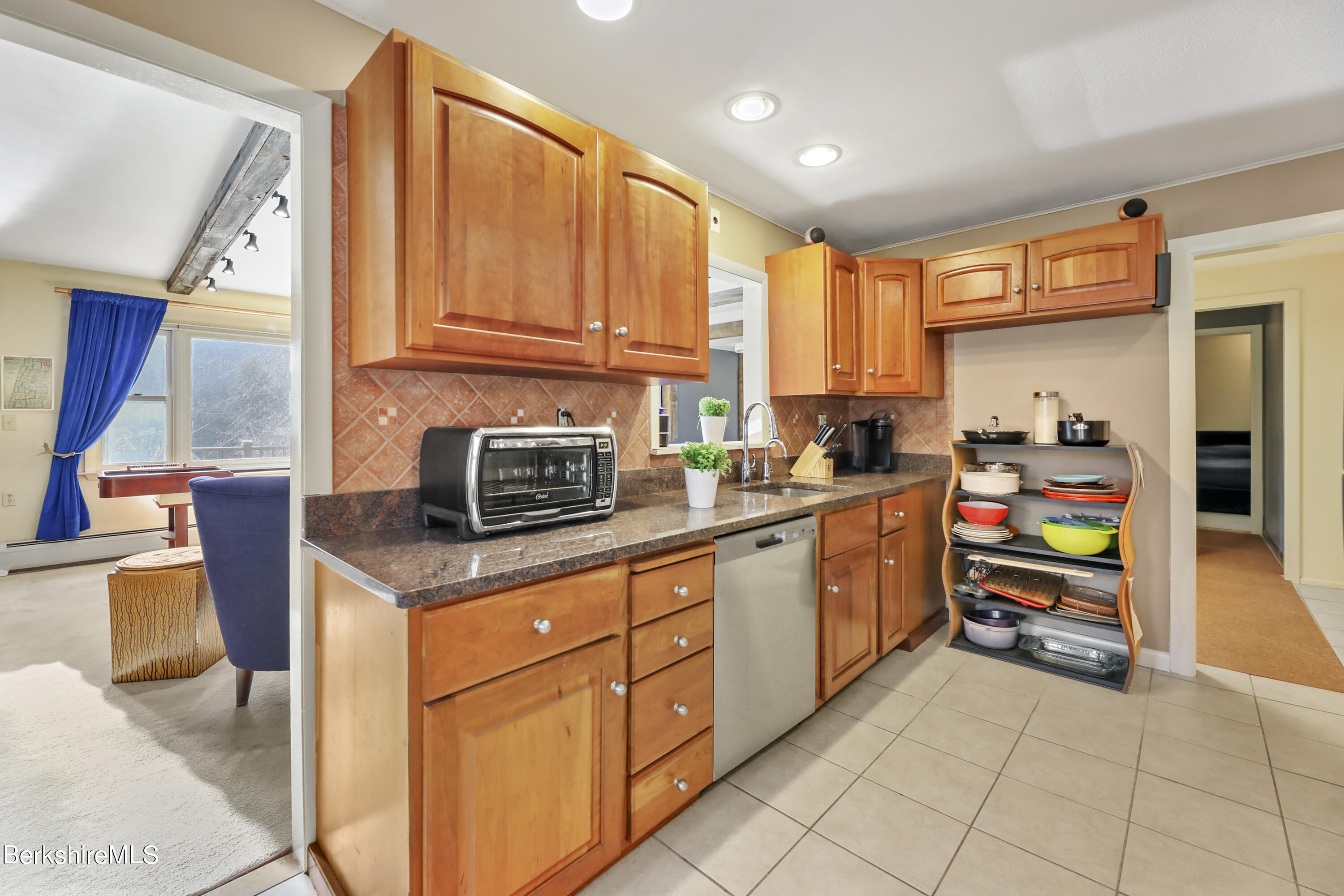 1831 North Main Road Otis, MA 01253 - Photo 29 of 69 a kitchen with stainless steel appliances granite countertop a stove a sink and a refrigerator