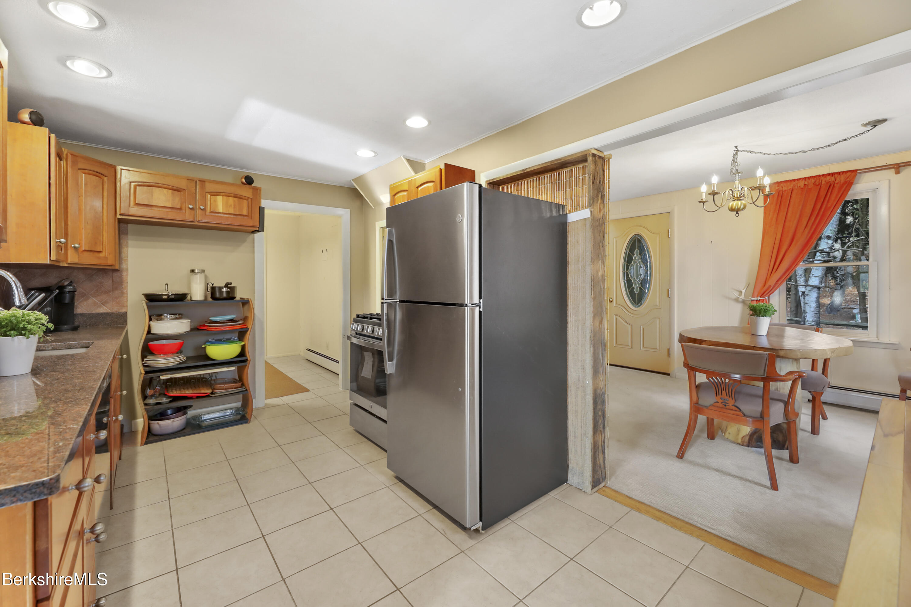 1831 North Main Road Otis, MA 01253 - Photo 30 of 69 a kitchen with stainless steel appliances kitchen island granite countertop a refrigerator and a stove top oven