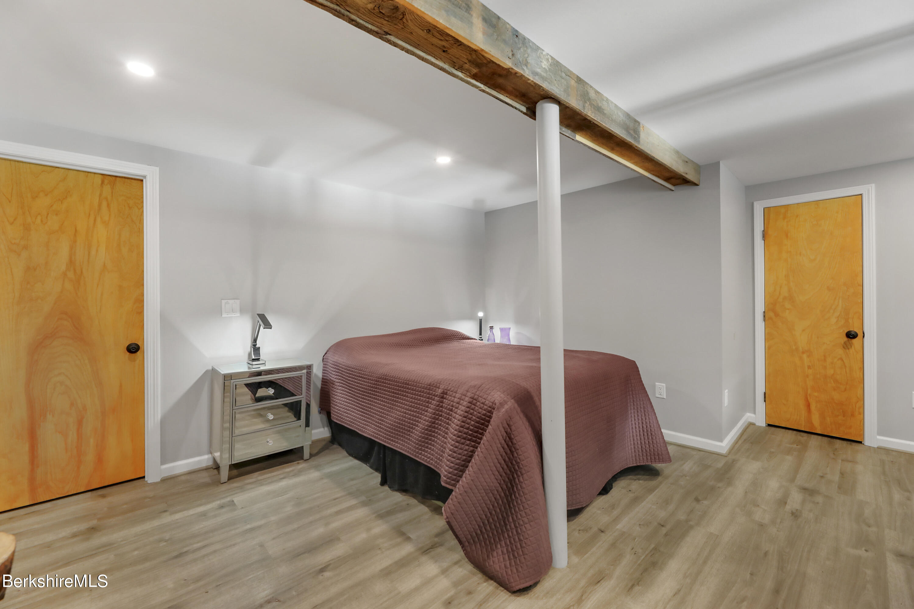 1831 North Main Road Otis, MA 01253 - Photo 63 of 69 a spacious bedroom with a bed and a table