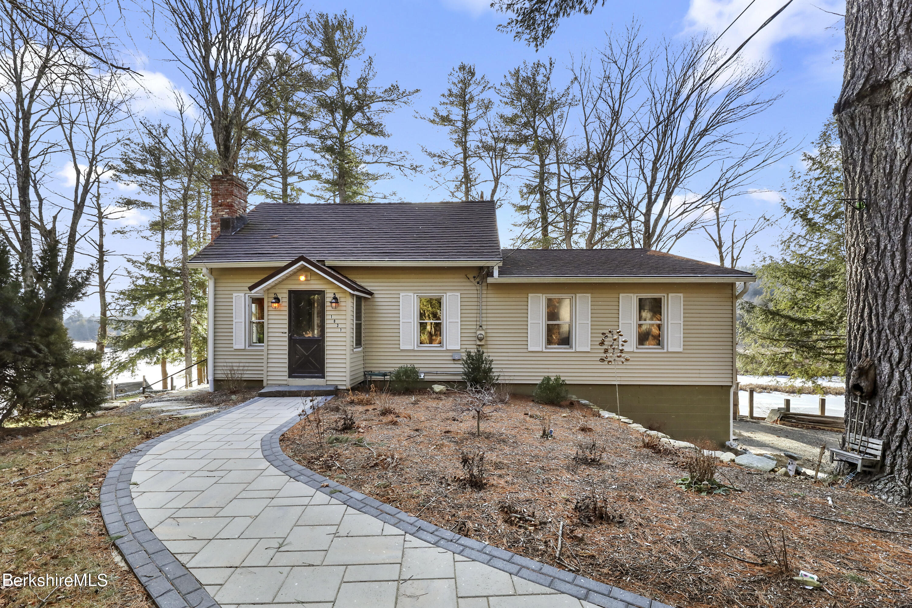1831 North Main Road Otis, MA 01253 - Photo 8 of 69 a front view of a house with a yard and garage