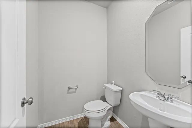 a white toilet sitting next to a bathroom sink