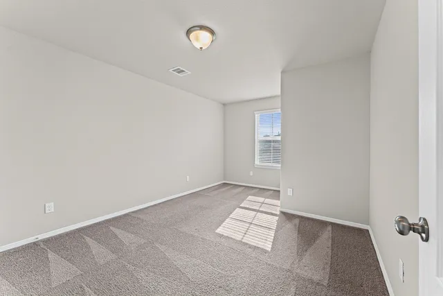 an empty room with a empty space and windows