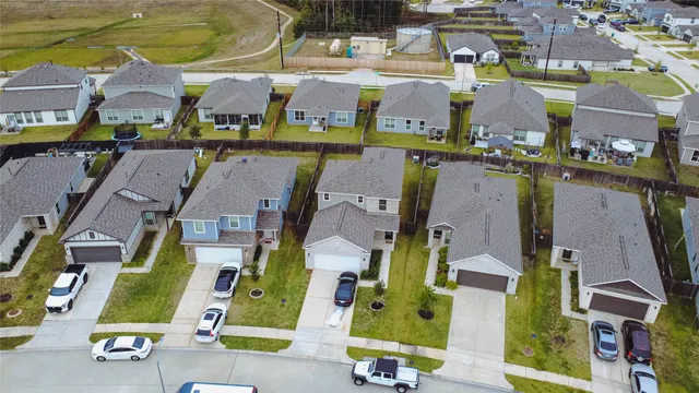 an aerial view of residential houses with outdoor space