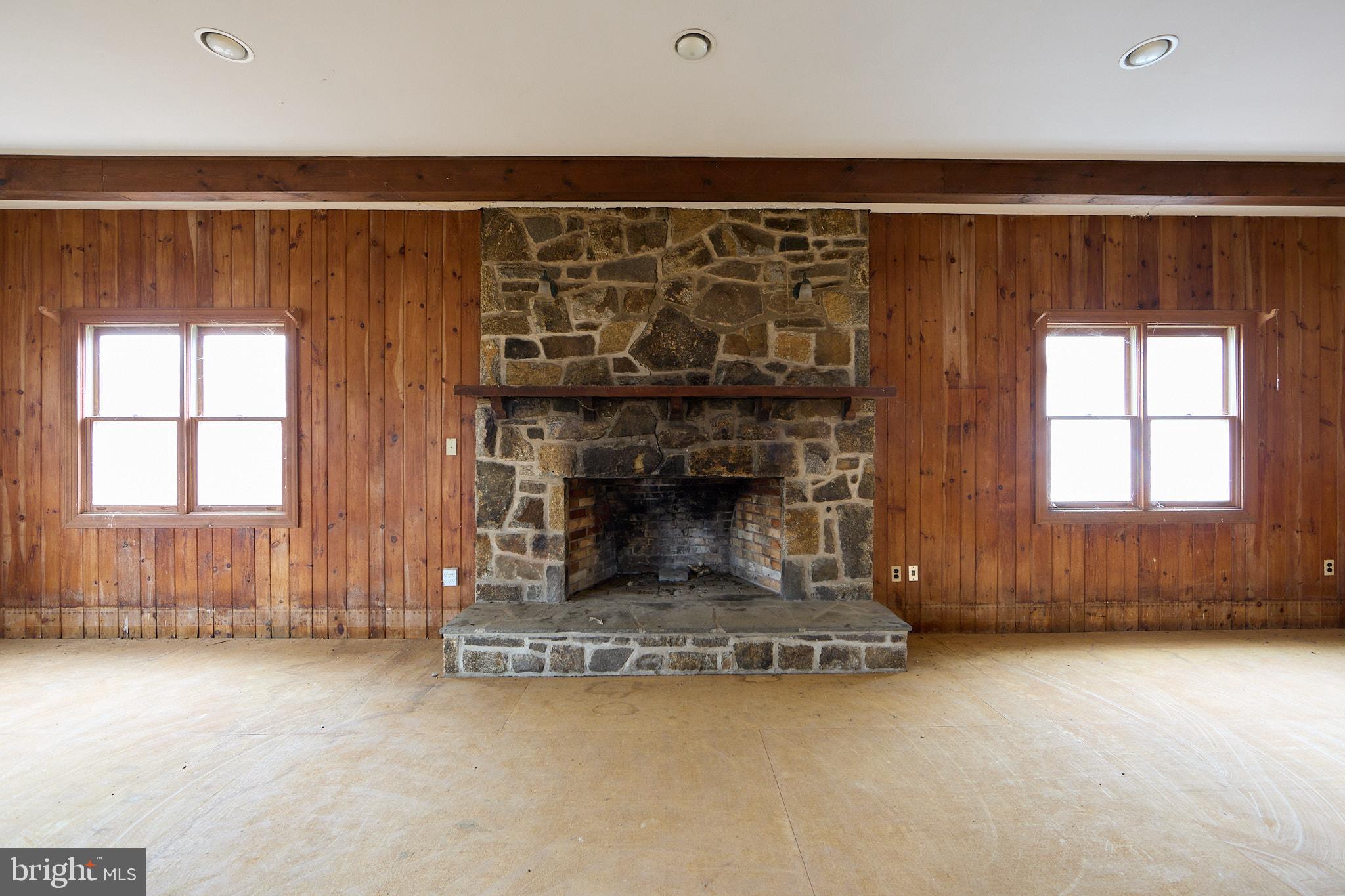1089 Nesbitt Road Colora, MD 21917 - Photo 58 of 78 an empty room with a fireplace and windows