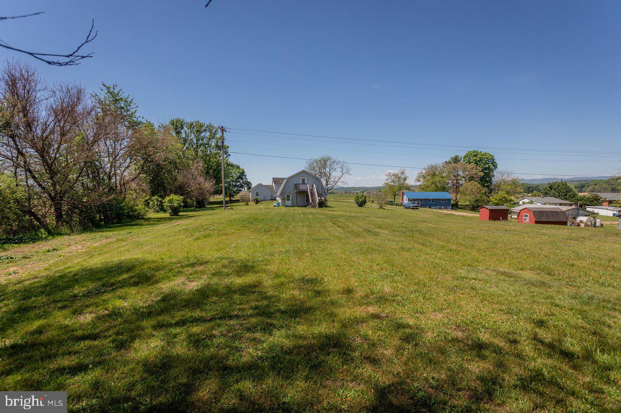 1751 Orchard Road Mount Jackson, VA 22842 - Photo 24 of 30 a view of a field with cars parked in front of it