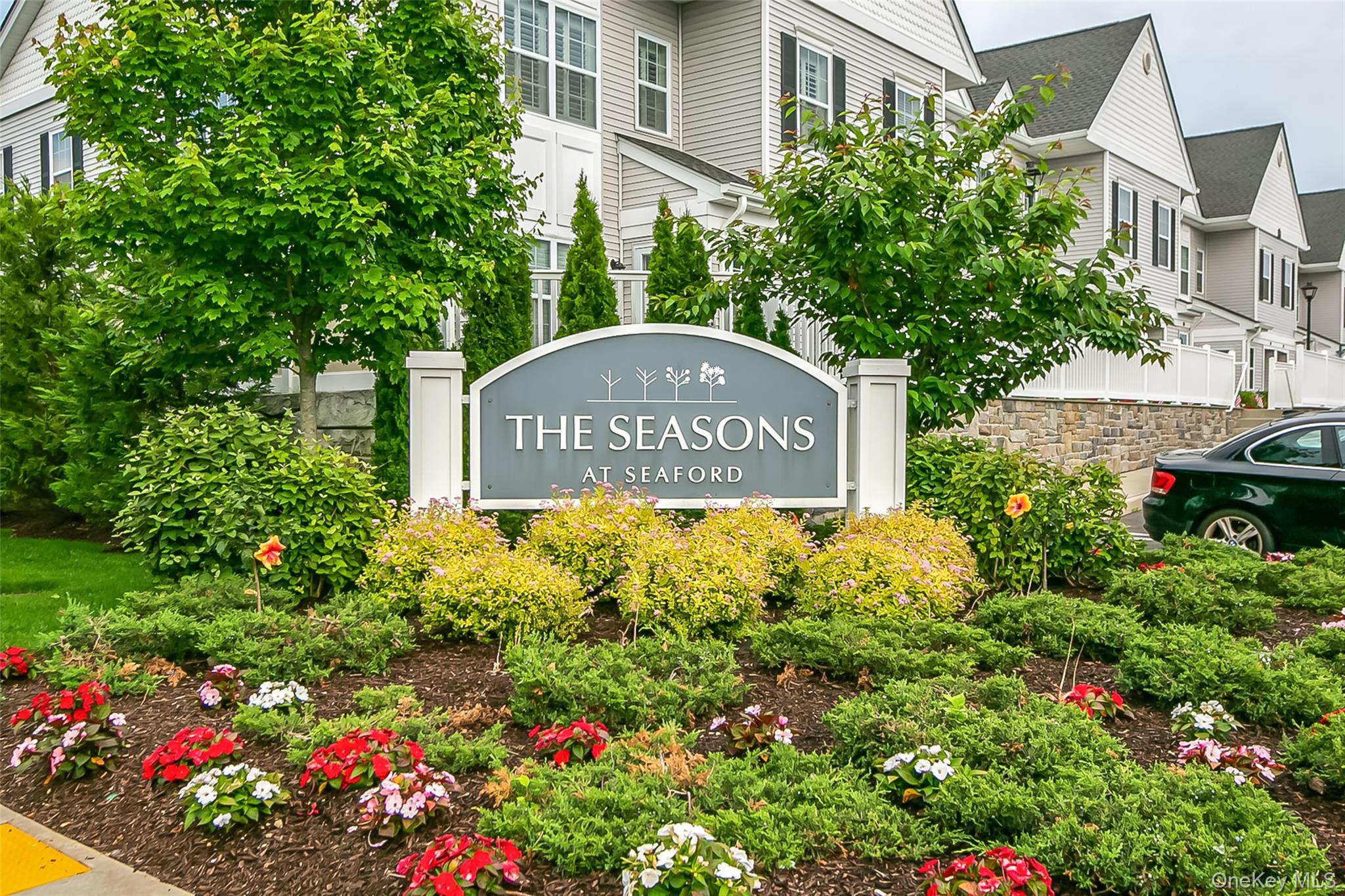a sign broad in front of flowers