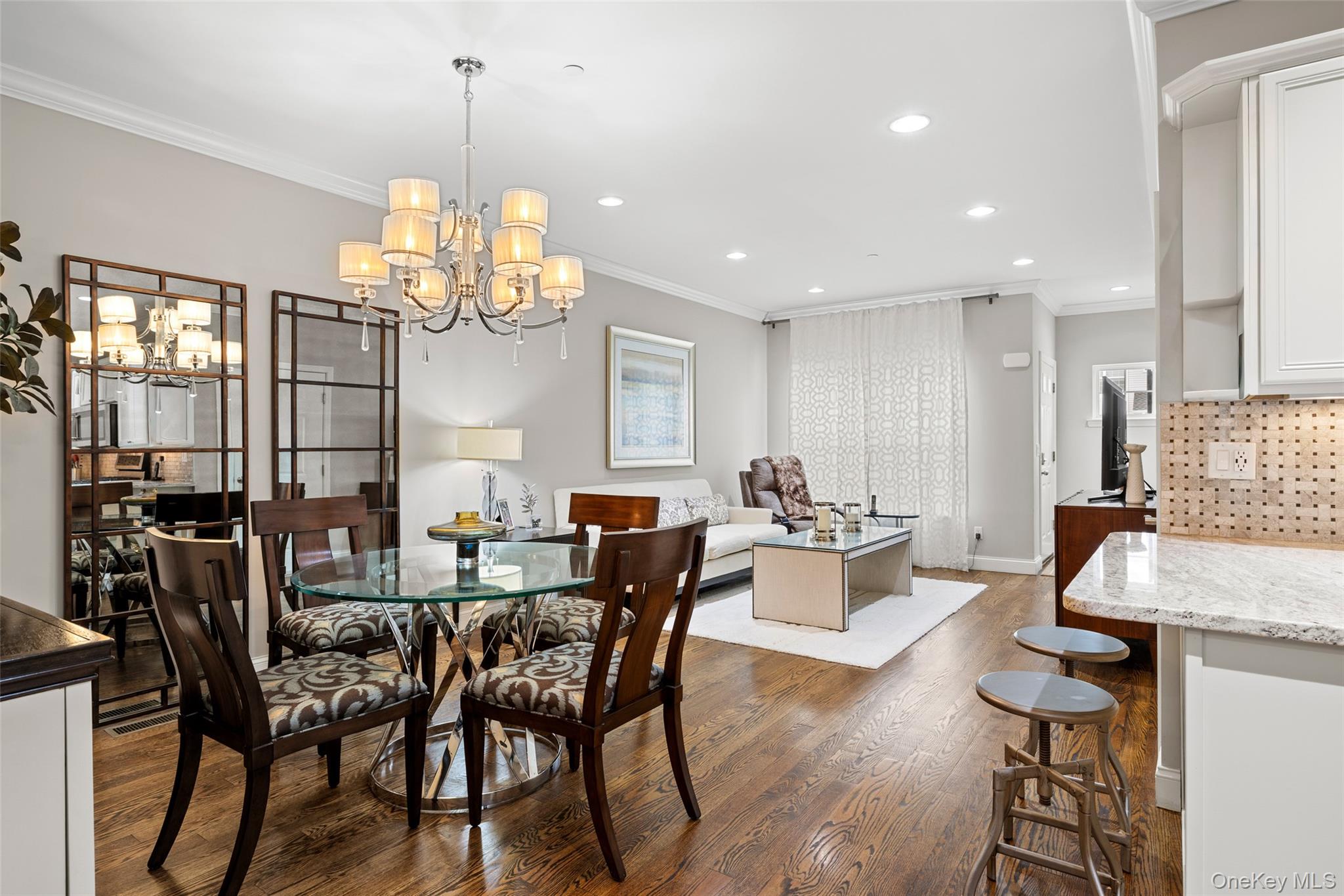 56 Spring Drive Seaford, NY 11783 - Photo 11 of 42 a view of a dining room with furniture a chandelier and wooden floor