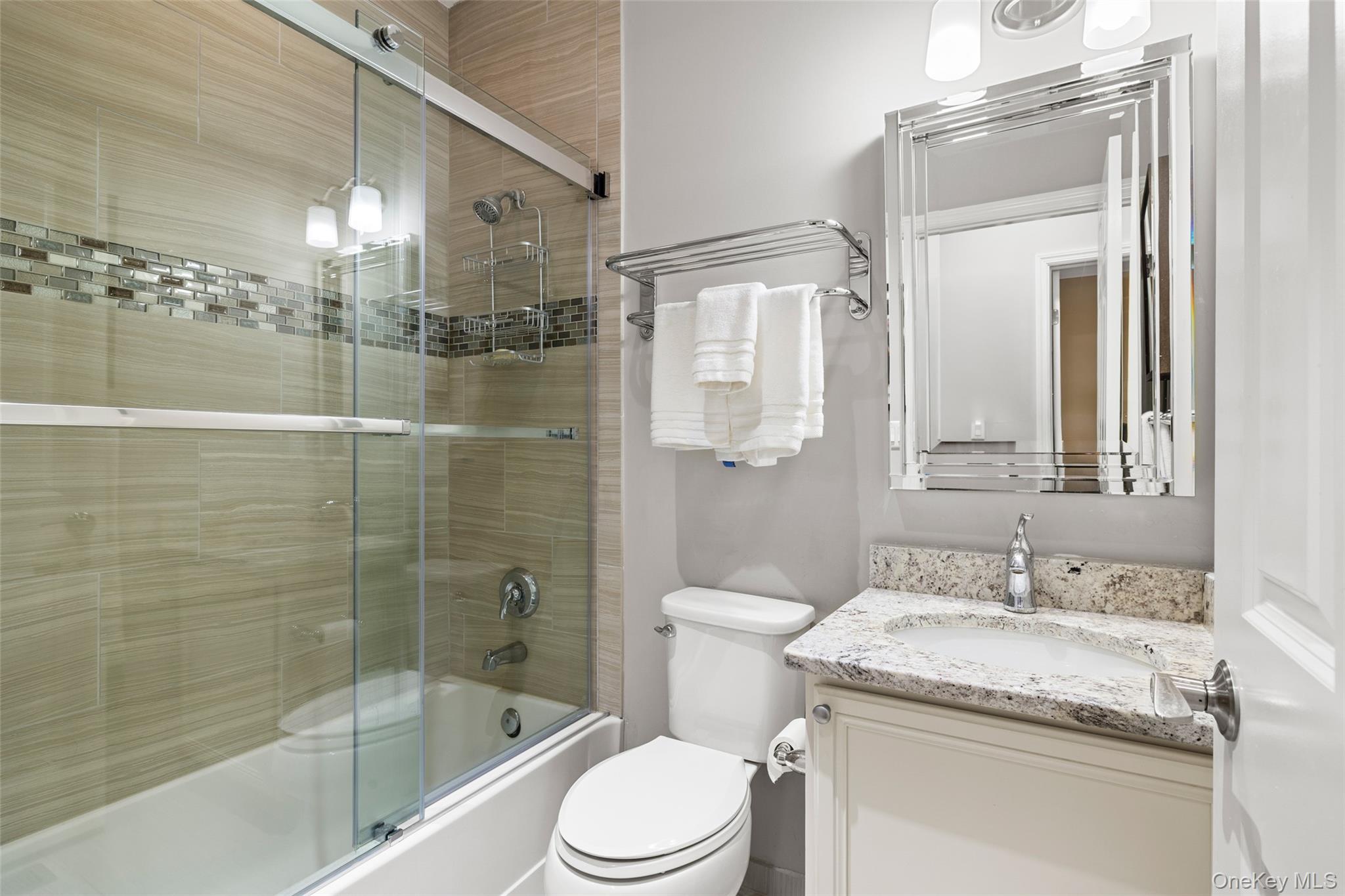 56 Spring Drive Seaford, NY 11783 - Photo 12 of 42 a bathroom with a granite countertop sink a toilet and shower