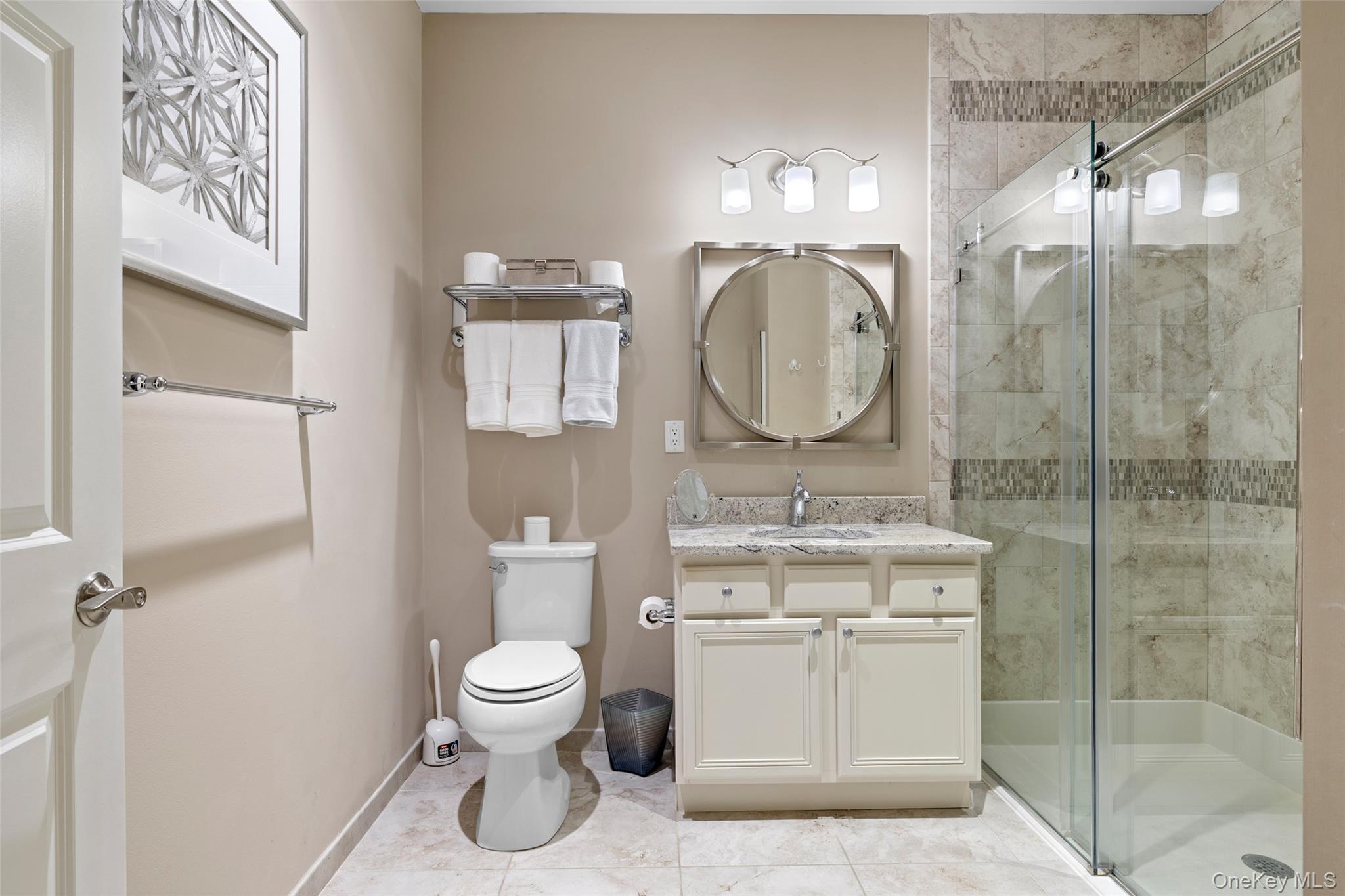 56 Spring Drive Seaford, NY 11783 - Photo 15 of 42 a bathroom with a toilet sink and mirror