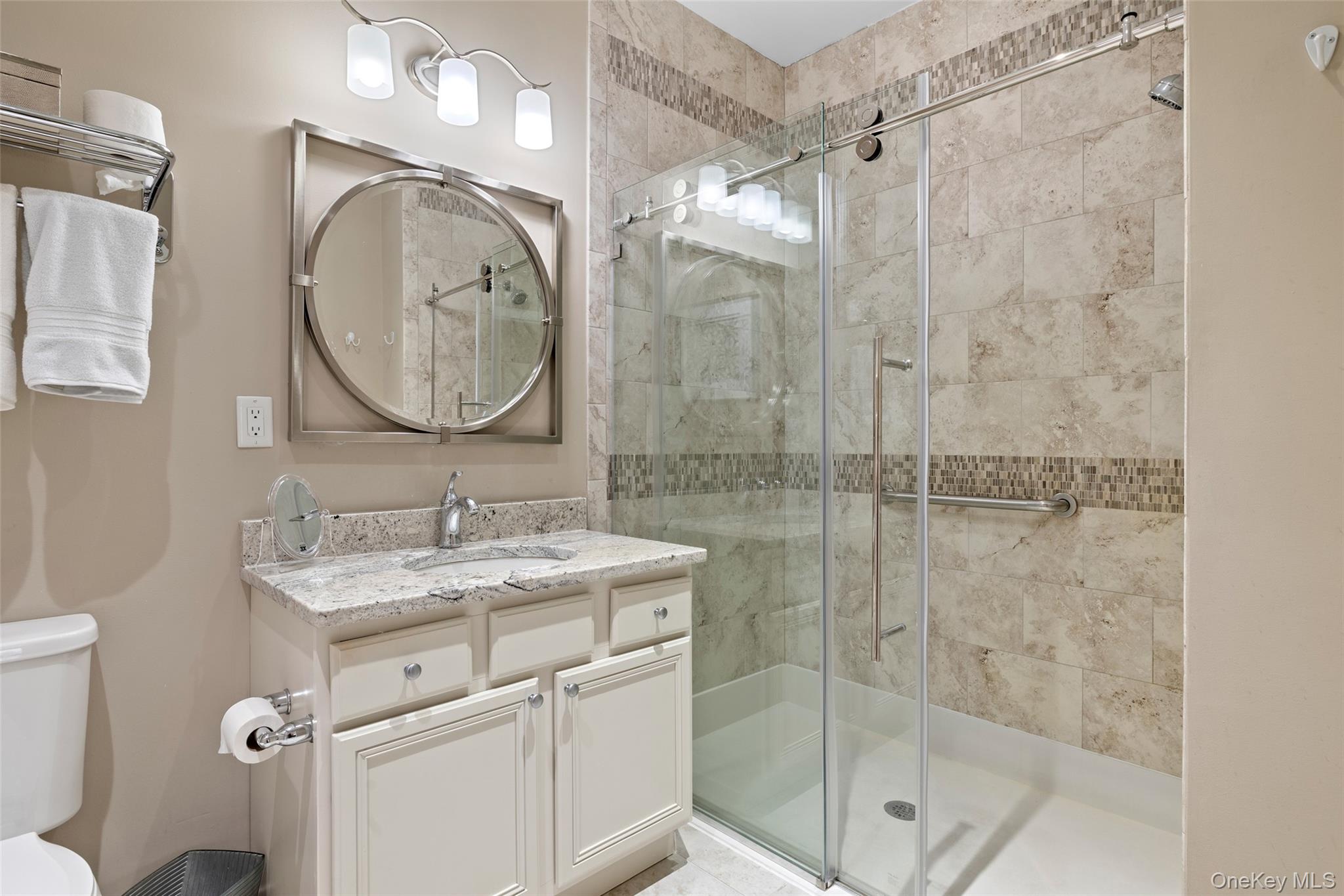 56 Spring Drive Seaford, NY 11783 - Photo 16 of 42 a bathroom with a granite countertop sink mirror and shower