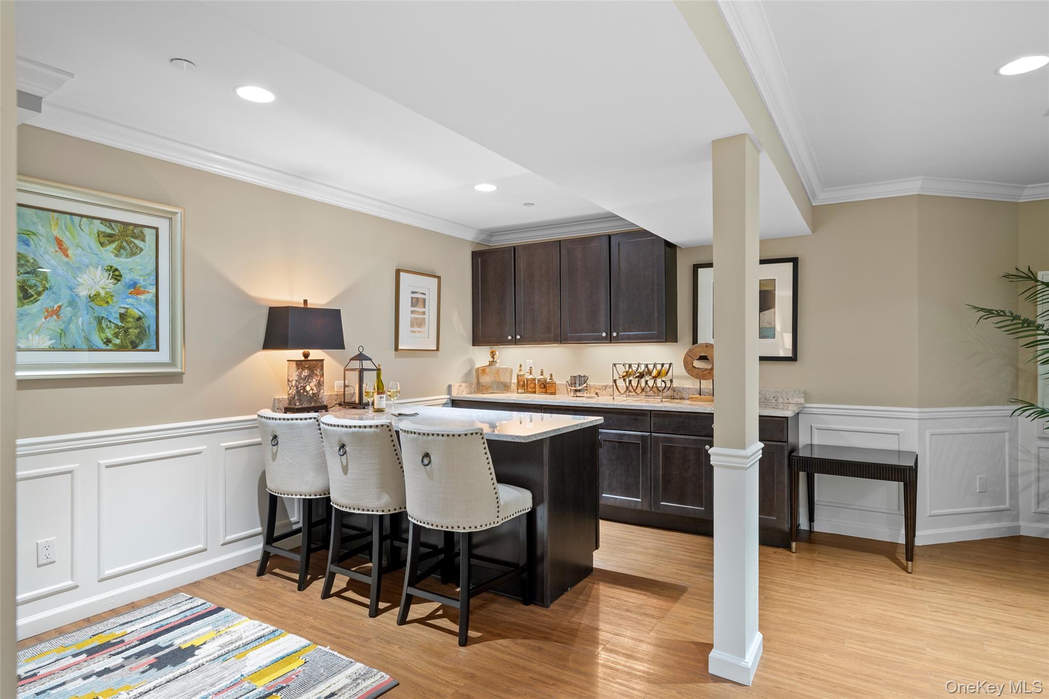 56 Spring Drive Seaford, NY 11783 - Photo 22 of 42 a kitchen with a dining table chairs and sink