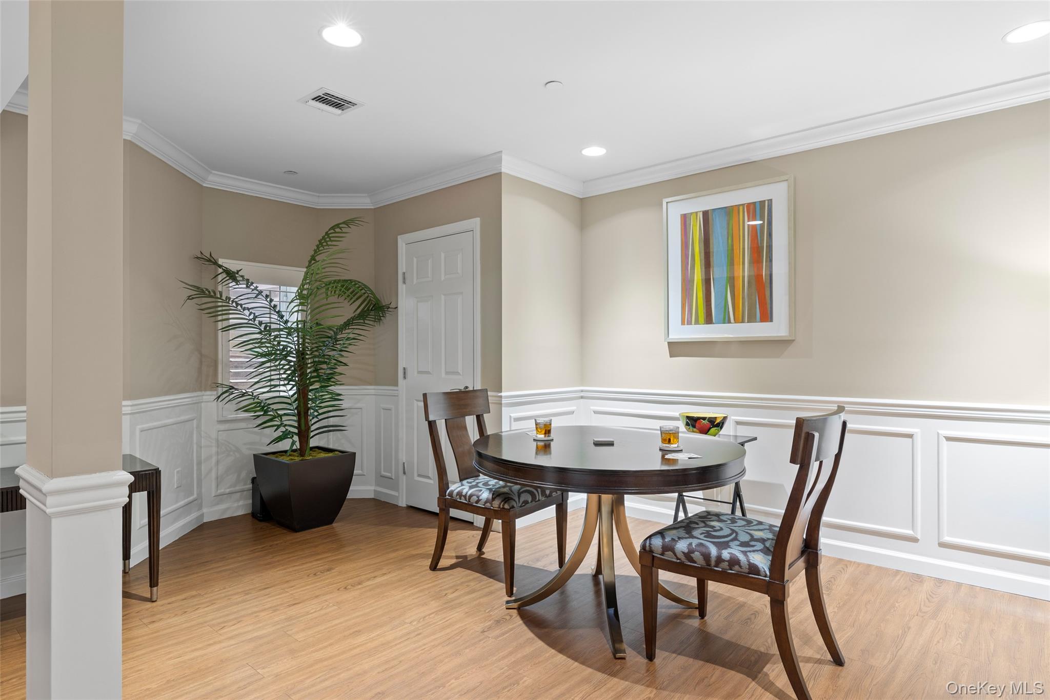 56 Spring Drive Seaford, NY 11783 - Photo 23 of 42 a view of a dining room with furniture and potted plants