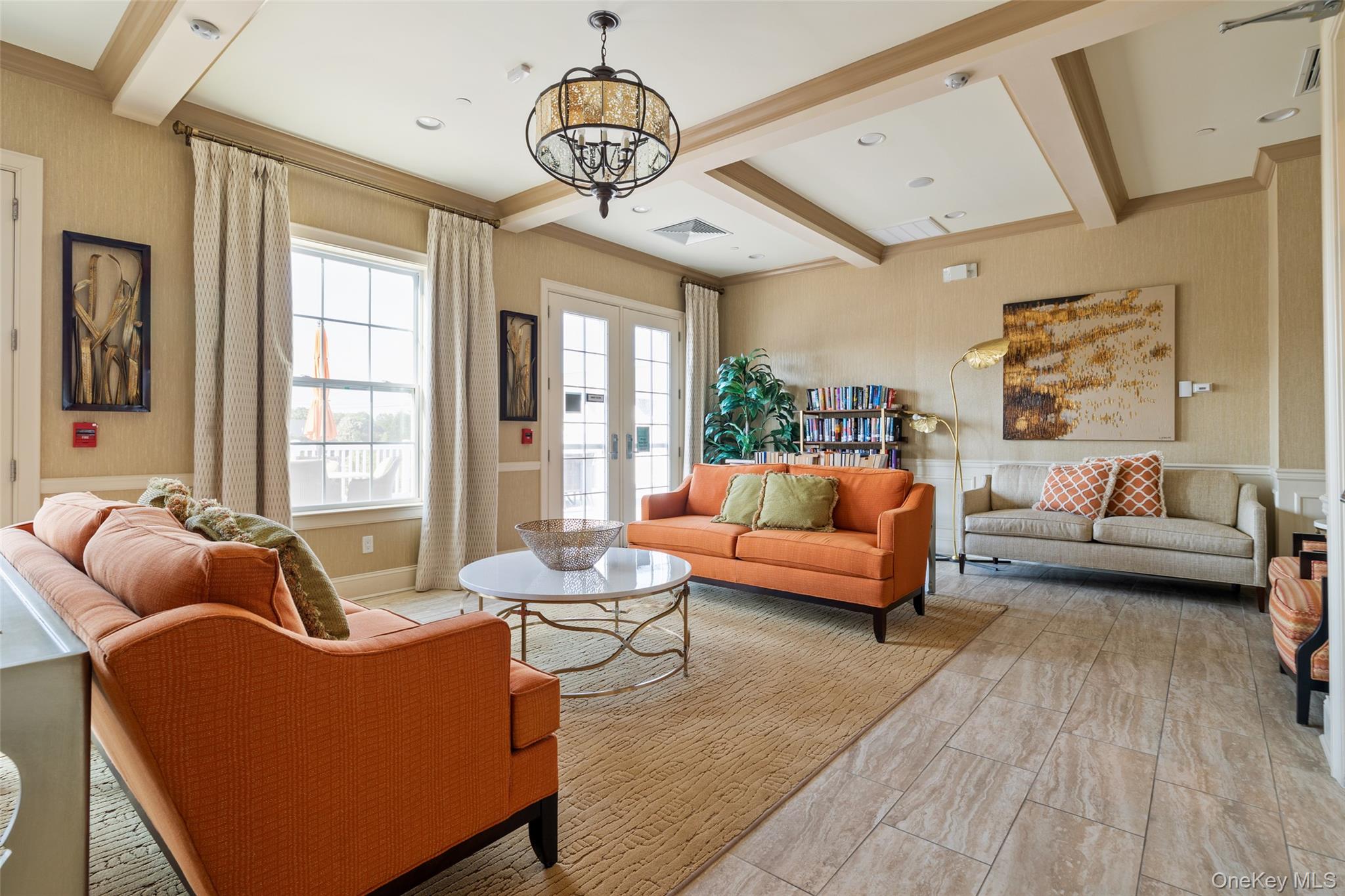 56 Spring Drive Seaford, NY 11783 - Photo 34 of 42 a living room with furniture chandelier and a large window