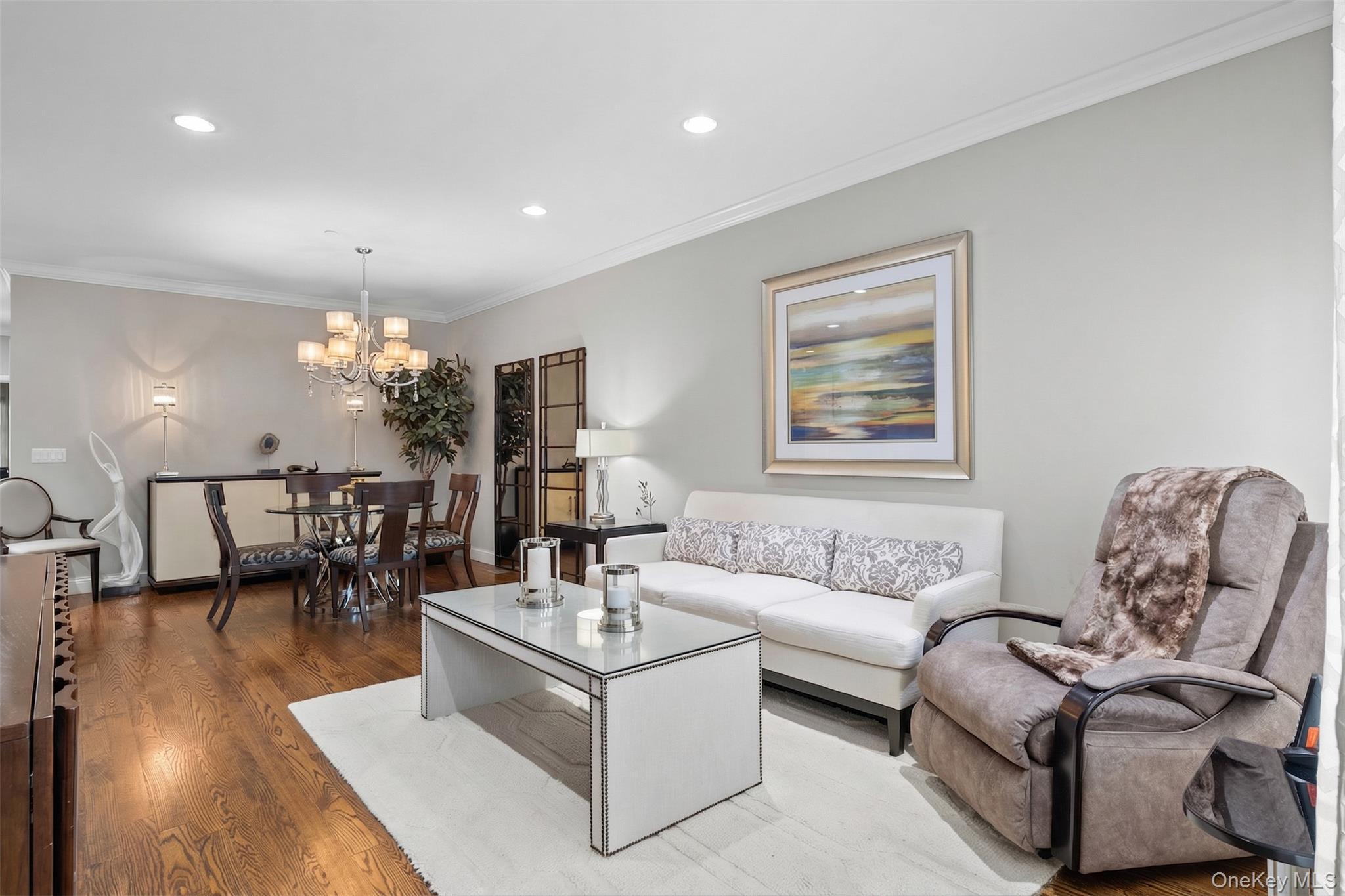 56 Spring Drive Seaford, NY 11783 - Photo 4 of 42 a living room with furniture and a chandelier