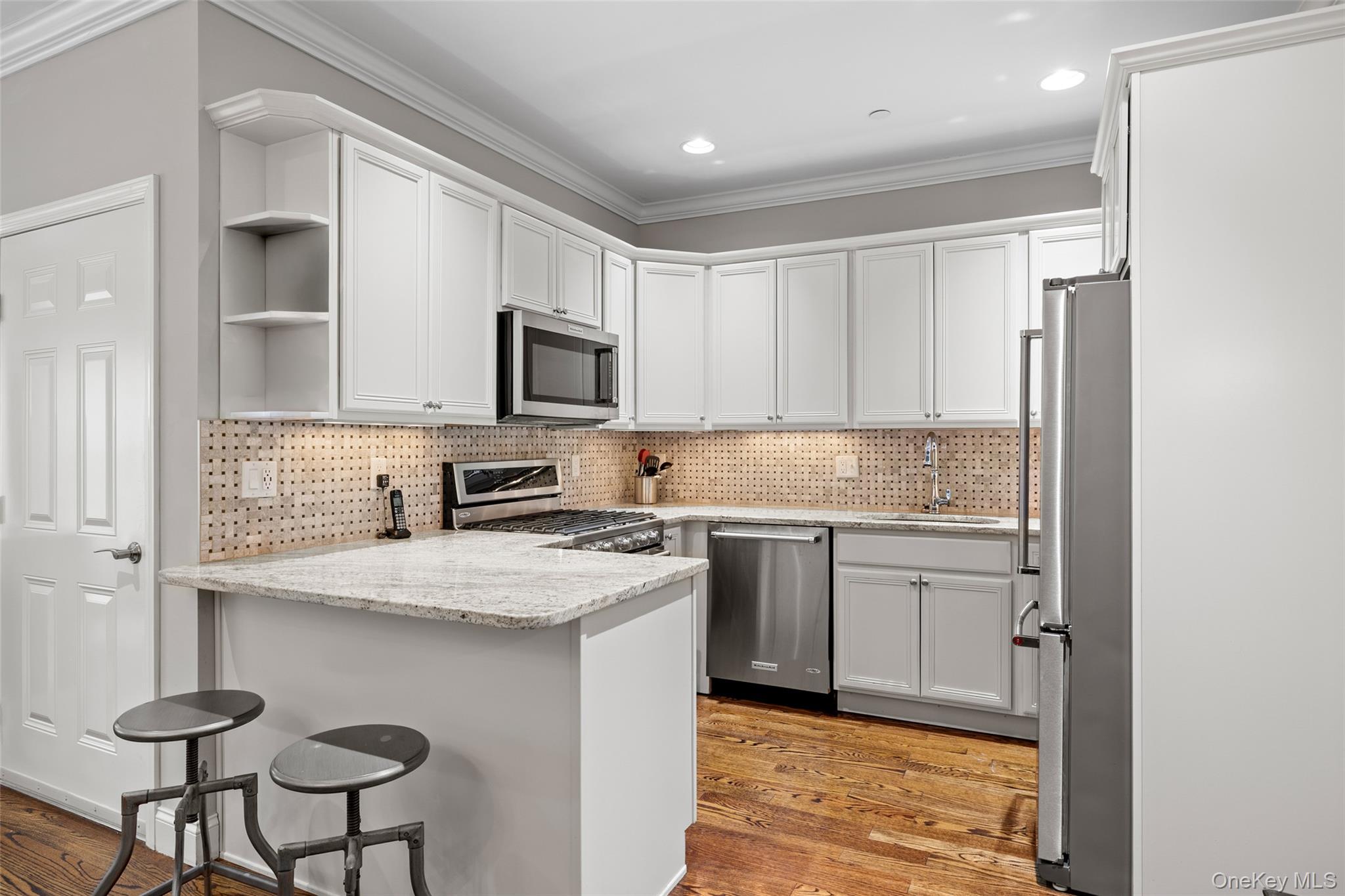 56 Spring Drive Seaford, NY 11783 - Photo 9 of 42 a kitchen with stainless steel appliances granite countertop a stove a sink and a refrigerator