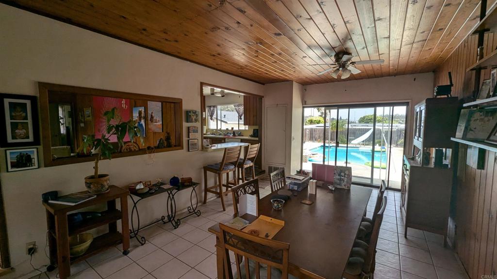5158 Los Robles Drive Carlsbad, CA 92008 - Photo 14 of 31 a living room with furniture a flat screen tv and floor to ceiling window