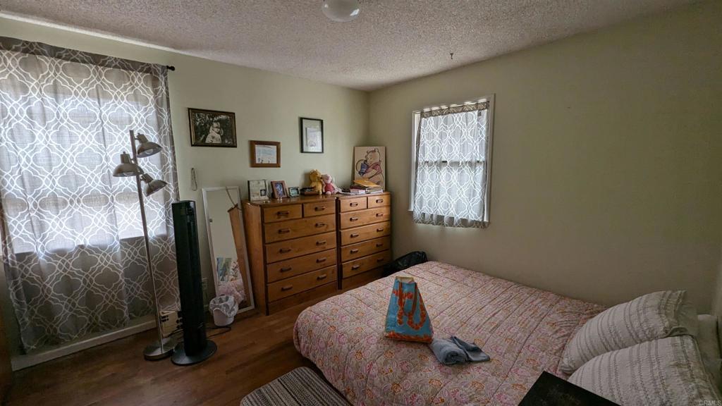 5158 Los Robles Drive Carlsbad, CA 92008 - Photo 15 of 31 a bedroom with a bed and wooden floor