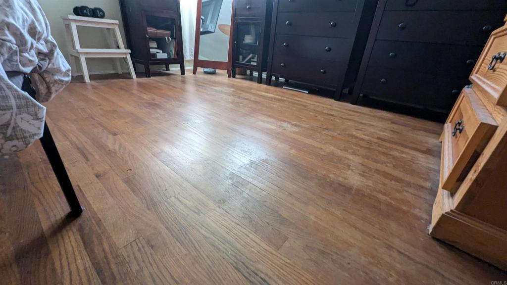 5158 Los Robles Drive Carlsbad, CA 92008 - Photo 19 of 31 a view of an empty room with wooden floor and a fireplace