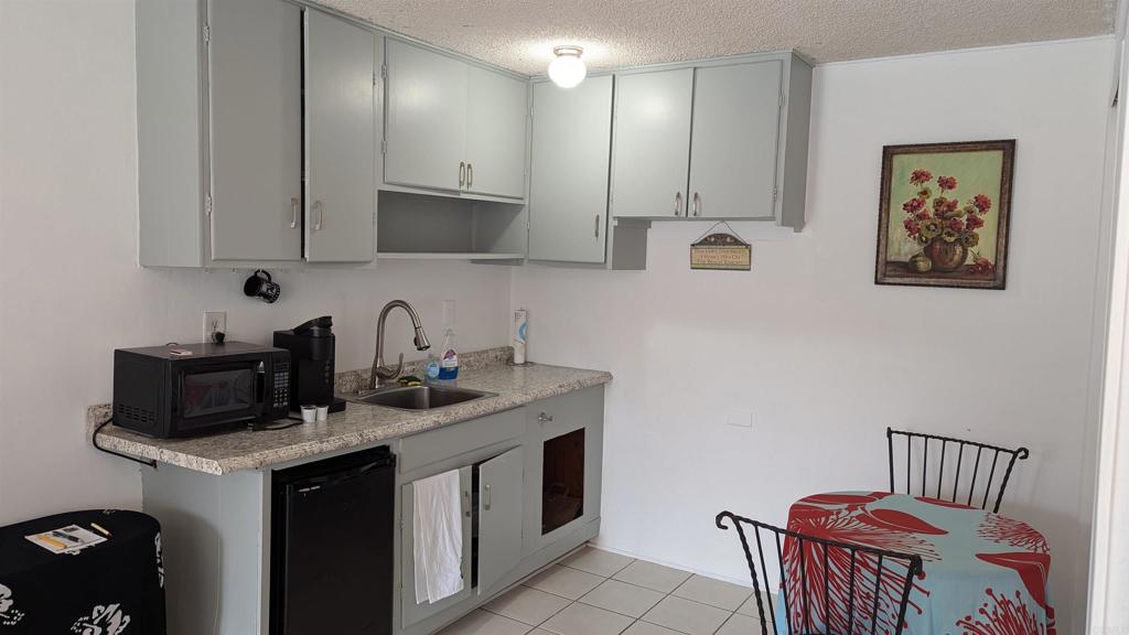 5158 Los Robles Drive Carlsbad, CA 92008 - Photo 23 of 31 a kitchen with stainless steel appliances granite countertop a sink stove and cabinets
