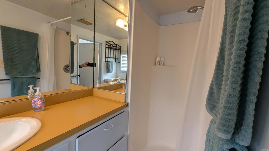 5158 Los Robles Drive Carlsbad, CA 92008 - Photo 26 of 31 a bathroom with a sink and a mirror