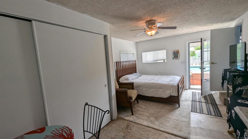 5158 Los Robles Drive Carlsbad, CA 92008 - Photo 28 of 31 a bedroom with a bed and a chandelier