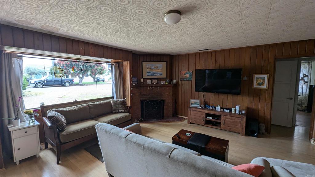 5158 Los Robles Drive Carlsbad, CA 92008 - Photo 3 of 31 a living room with furniture a fireplace and a flat screen tv