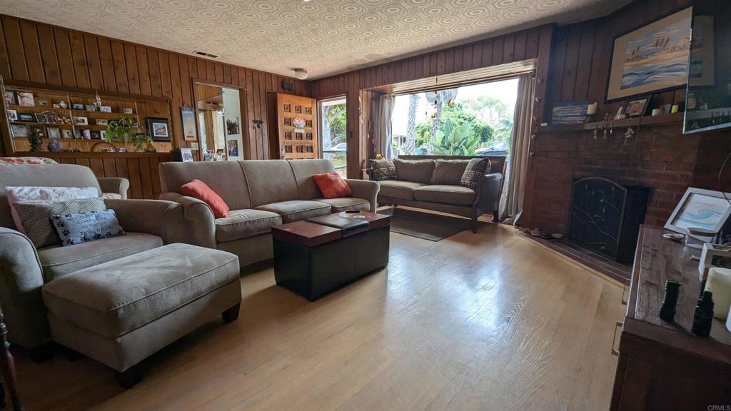 5158 Los Robles Drive Carlsbad, CA 92008 - Photo 5 of 31 a living room with furniture window and a fireplace