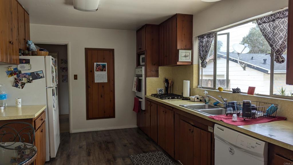 5158 Los Robles Drive Carlsbad, CA 92008 - Photo 10 of 31 a kitchen with a sink stove and refrigerator