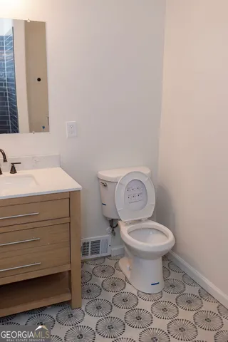 a bathroom with a toilet a sink and a mirror