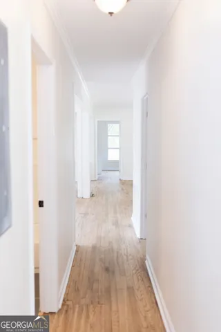 a view of a hallway with wooden floor