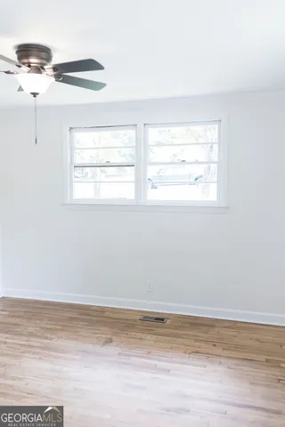 a view of a room with wooden floor