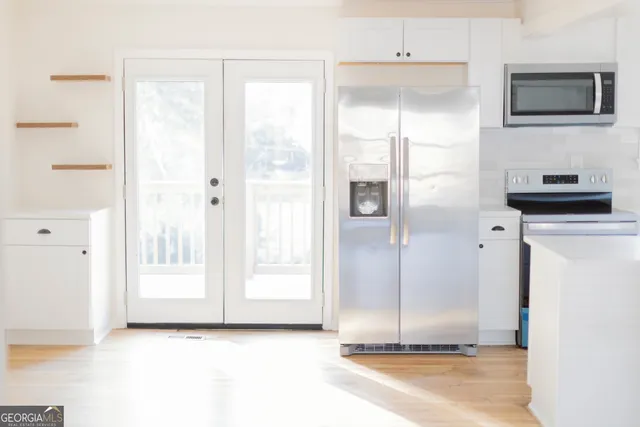 a view of a kitchen with a sink and a refrigerator