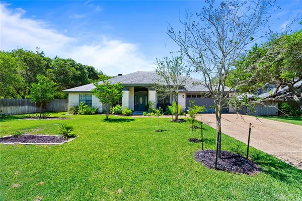 a view of a house with a backyard