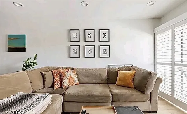 a living room with furniture and painting on the wall