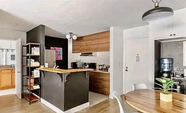 a view of a workspace room with furniture and wooden floor