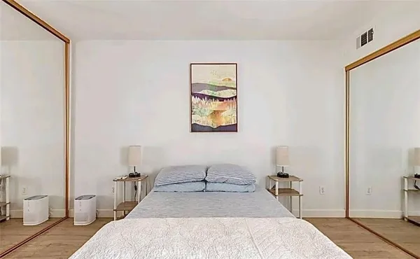 a bed room with a bed and a chair