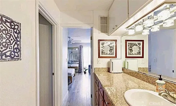 a en suite bathroom with a granite countertop double vanity sink and a mirror